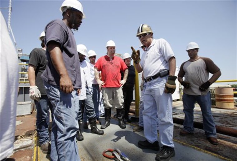 Instructor Ted Abshire, second from right, speaks to students during an oil rig training exercise in Morgan City, La. 